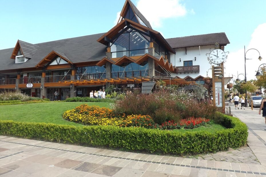 Prédio em estilo alpino com relógio e jardim florido no centro de Gramado, na Serra Gaúcha (RS)